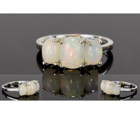 Opal Trilogy Ring, the central, elongated cushion cut opal flanked by two slightly smaller, similar, set in platinum vermeil 