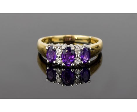10ct Diamond And Amethyst Ring Set with three amethysts of good colour surrounded by multiple diamond chips