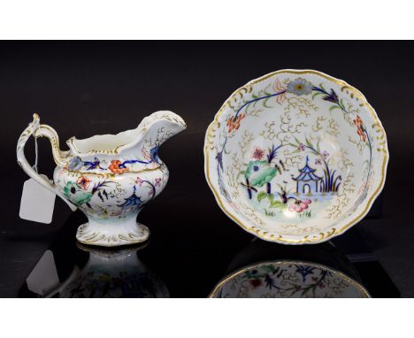 A Wash Bowl And Ewer Miniature wash bowl in white ceramic with blue, red and green Chinoiserie pattern and gilt trim. Good co