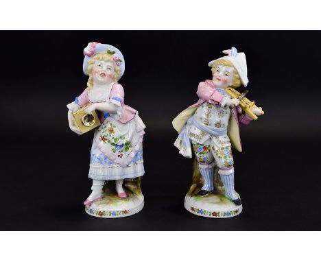 Conta and Boehme Pair of Child Musician Matchbox Holder Figures, both boy and girl dressed in a pastiche of adult late 18th c