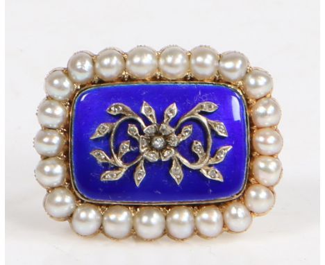 the rectangular brooch with central diamond chip set floral spray on a blue enamel cushion form centre surrounded by a band o