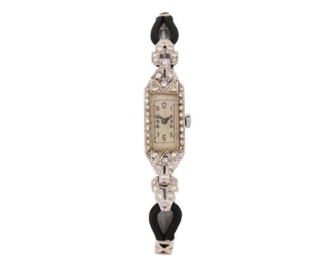 the white dial with Arabic numerals and outer minutes track, manual wound, the platinum case set with round cut diamonds and 