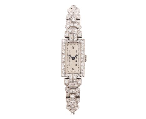 the rectangular white dial with Arabic numerals, manual wound, the case and shoulders set with round brilliant cut diamonds, 