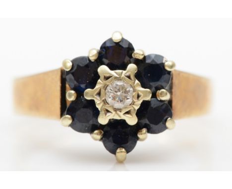 A 9ct gold brilliant cut diamond and sapphire cluster ring, K-L, 2.6gm. 