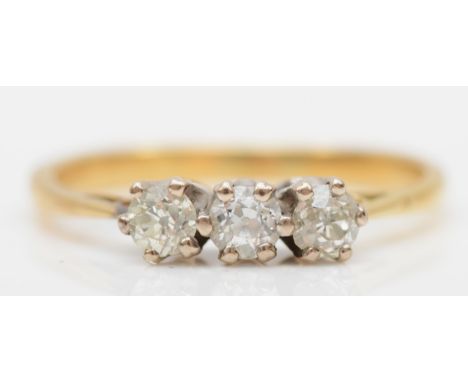 An unmarked gold brilliant cut diamond three stone ring, I-J, 1.8gm. 