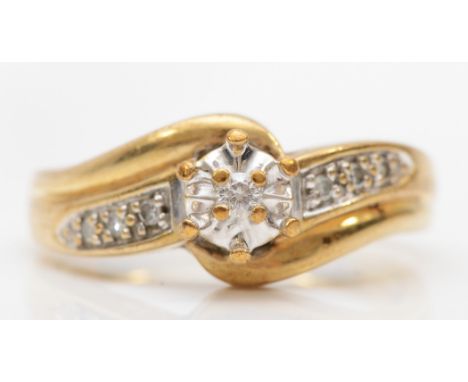 A 9ct gold brilliant cut and melee diamond dress ring, K-L, 3gm. 