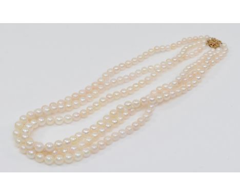 A 14ct gold clasped three strand graduating cultured pearl necklace, 4 - 7mm pearls. 
