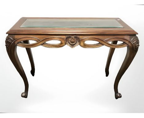 A reproduction mahogany glazed console table, width 110 cm.