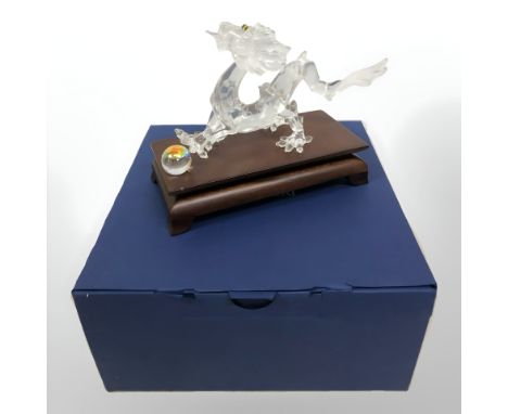 A Swarovski figure of a Chinese dragon with pearl, boxed.