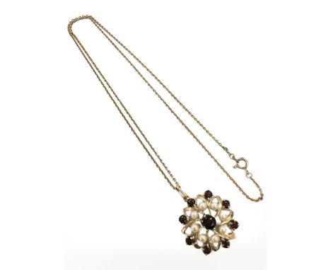 A yellow gold garnet and seed pearl pendant, diameter 20 mm, suspended on 9ct yellow gold chain, length 45.5 cm. CONDITION RE