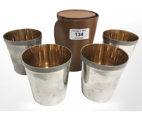 A set of four silver plated stirrup cups with gilded interiors, in stitched leather case.