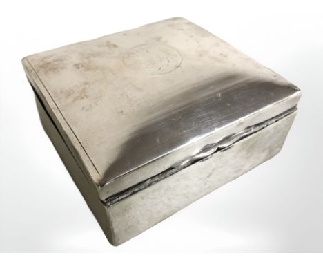 A silver cigarette box, width 9 cm, together with a three piece silver backed dressing table brush set.