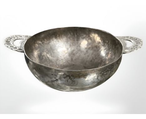 An Arts and Crafts hand forged twin handled silver bowl, diameter 19 cm. CONDITION REPORT: 138.9g, no apparent marks. 
