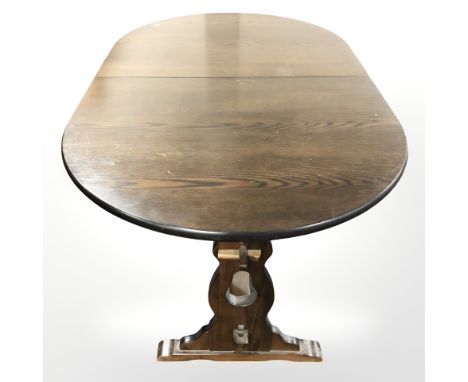 A traditional style oak extending dining room table and six ladder back farmhouse style chairs 