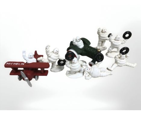 A group of Michelin men, novelty tractor and aeroplane figure.