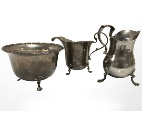 A silver cream jug, Chester, 1905, together with a silver sugar bowl and further silver cream jug.  CONDITION REPORT: Gross w