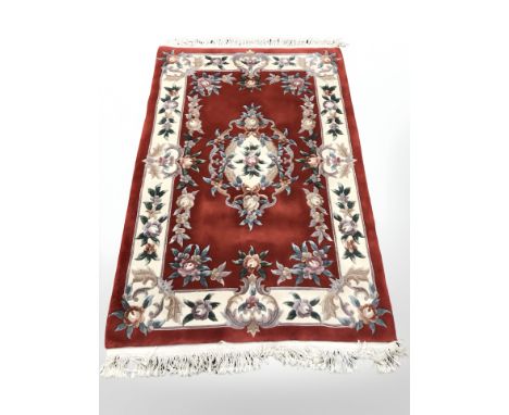 A Chinese carpet on red ground, 182 cm x 124 cm 