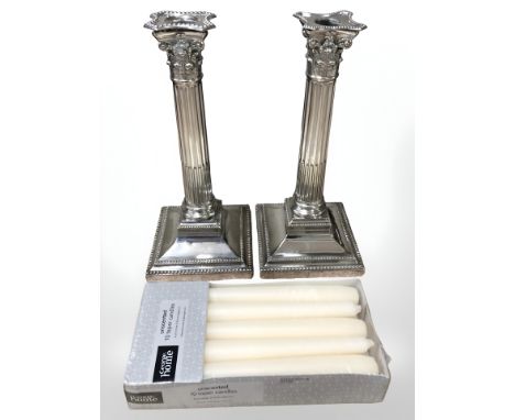 A pair of Walker & Hall silver plated corinthian column candlesticks, height 26 cm.