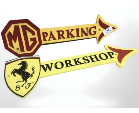 Two cast arrow car signs.
