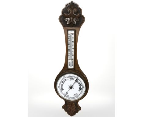 A Victorian oak aneroid barometer.