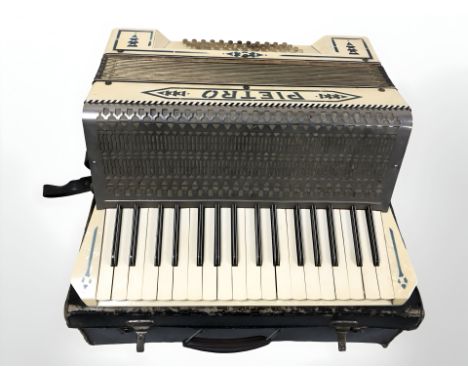 A Pietro piano accordion in case.