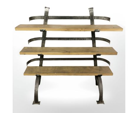 A heavy quality oak and iron three tier shelf, width 128 cm.