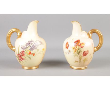 A pair of Royal Worcester blushware jugs decorated with poppies, bluebells and gilt handles. 13cm tall.  