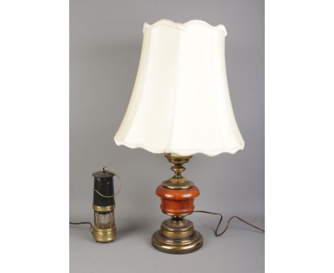 A brass and wooden bodied table light, together with a miners lamp; which has been converted to electric.  