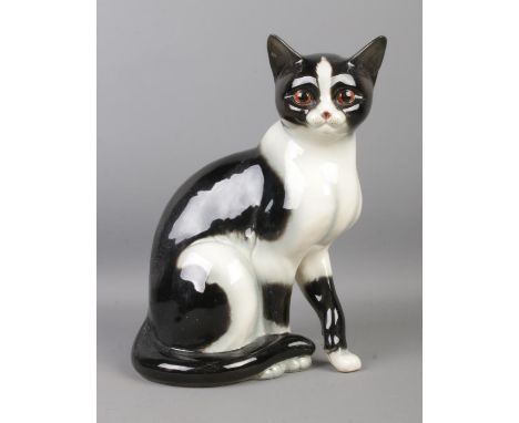 A large Goebel ceramic black and white cat figurine. Height: 27cm. Stamped 31023-27 underneath.  