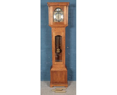 A modern carved oak longcase clock. With floral decoration. (202cm x 45cm x 27cm)  