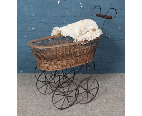 A vintage weaved wicker and metal pram.  
