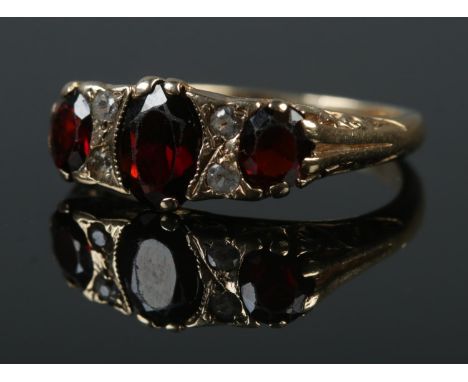 A 9ct gold garnet and clear stone ring. Size L 1/2. 3.45g.  