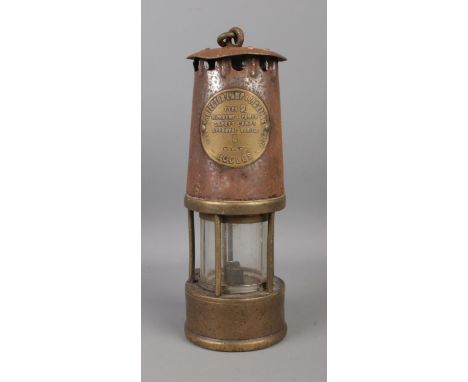 An Eccles Type SL Safety Lamp, by The Protector Lamp and Lighting Co Ltd. Stamped for marker '6'.  Some rusting to the top.