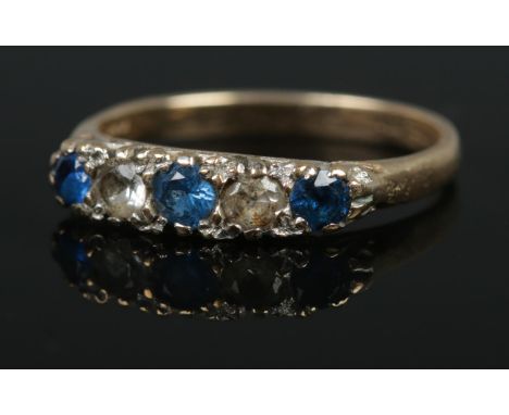 A five stone 9ct diamond and sapphire ring. Size L, 1.91g.  