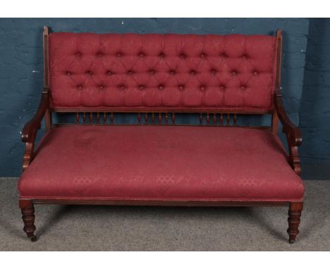 A Victorian mahogany parlour sofa with deep button upholstered back. Height 88cm, Width 125cm, Depth 65cm.  