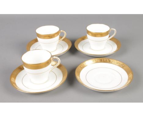 A collection of Davis Collamore &amp; Co for Minton tea cups and saucers featuring gilt decoration. Includes three teacups an