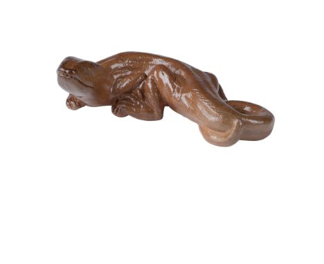 A finely crafted Royal Doulton stoneware figure of a lizard, designed by renowned artist Mark V. Marshall. The piece is skill