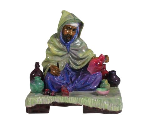 This is a Royal Doulton figurine titled The Potter, model number HN1518. Designed by renowned artist Charles Noke, this hand-