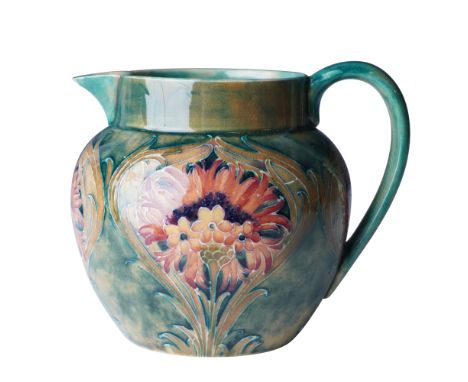 Designed by William Moorcroft, this exceptional pottery jug features the 'Cornflower' pattern with vibrant floral motifs in s
