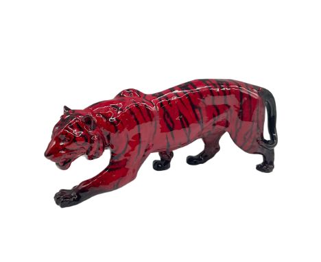 The Royal Doulton Flambe Tiger Stalking HN1082 is a distinguished ceramic piece designed by Charles Noke and Fred Moore. This