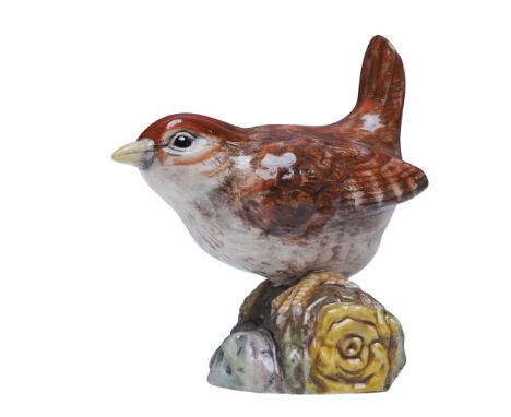 This rare Royal Doulton prototype figurine depicts a beautifully detailed wren perched on a log, capturing the natural charm 