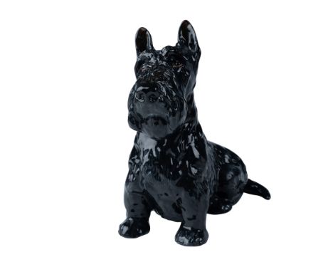 This charming Royal Doulton figurine depicts a seated Scottish Terrier in exquisite detail. Crafted from fine ceramic, the fi