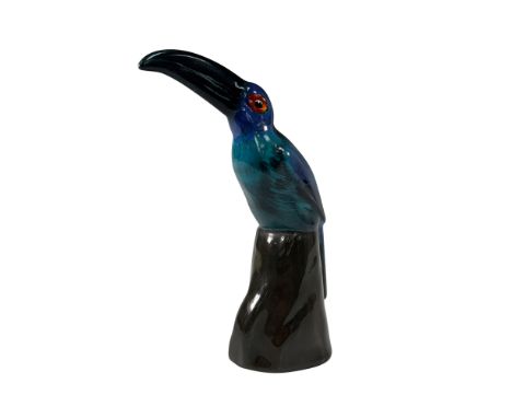 A rare Royal Doulton porcelain figure of a toucan perched on a rock, finished in a striking colorway variation. This exquisit