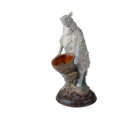 Cobridge Pottery stoneware sculpture featuring a seated sheep holding an empty half of a coconut shell. This whimsical yet in