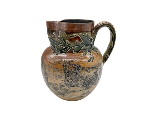 Hand decorated and hand modeled round pitcher that features an incised grassland setting with a lion pride. Green painted lea