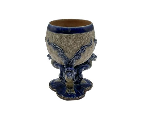 Attributed to Mark V. Marshall. A small footed goblet in brown and blue colored tones. The bowl is decorated in a circle patt