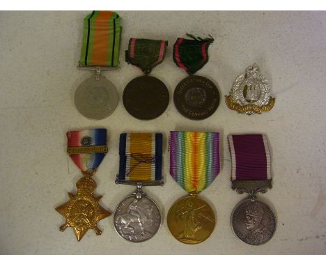 A 1914 Star with clasp and Rosette awarded to Pte H Moore 8919 2/Suffolk Regiment, a British War Medal 1914-18 and a Victory 