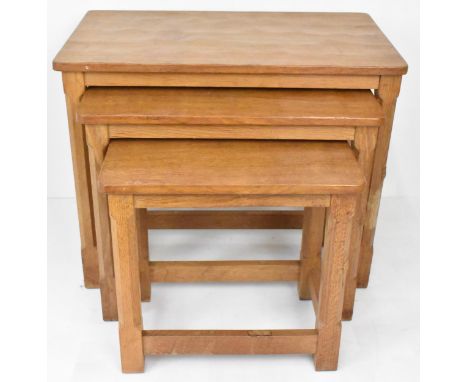 Robert 'Mouseman' Thompson (1876-1955) A nest of three graduating oak 'Mouseman' tables, circa 1979, each with adzed tops rai