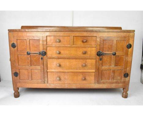 Robert 'Mouseman' Thompson (1876-1955) An oak panelled sideboard, circa 1955, adzed throughout, raised back rail, two short o