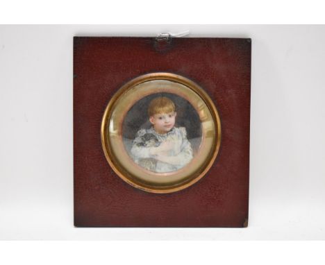 An Edwardian portrait miniature depicting a boy and a cat, watercolour on ivory, inscribed to the reverse and dated November 